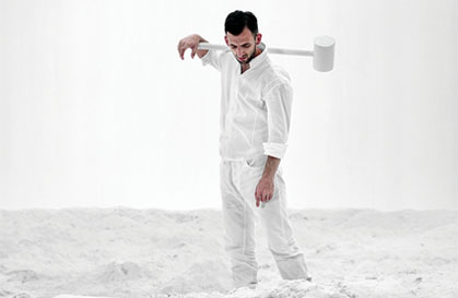 White sand, man dressed in white with white hammer image