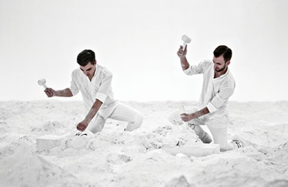 Men in white making sculpure image